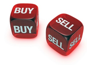 pair of translucent red dice with buy, sell sign